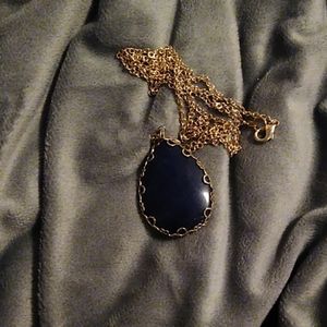Long gold necklace with blue pendent